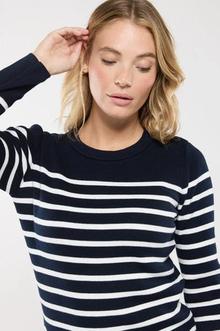 Woman wearing navy and white striped sweater with crew neck, casual fashion style