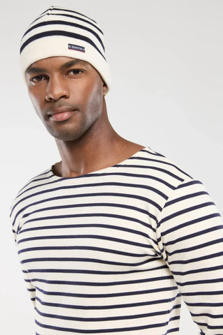 Man in white and navy striped shirt and beanie, close-up fashion portrait