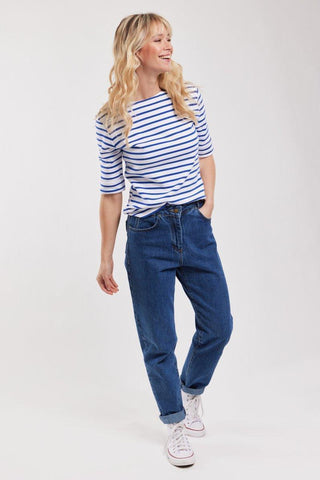 Woman wearing blue and white striped Breton shirt with 3/4 sleeves and blue jeans