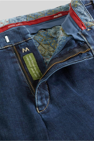 Close-up of blue Meyer jeans with open zipper, patterned inner lining, organic cotton label