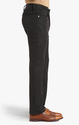 Side view of men's brown tweed pants styled with tan dress shoes on a white background
