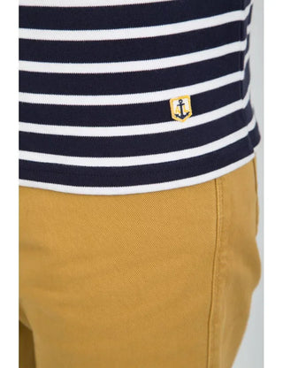 Navy and white striped cotton Breton shirt with anchor patch, paired with mustard pants