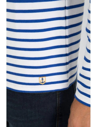 Blue and white striped cotton marinière shirt with anchor patch, paired with dark denim jeans.