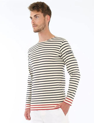 Man wearing a striped long sleeve marinière shirt with navy and red accents