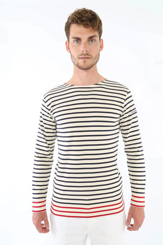 Man wearing a long sleeve navy and white striped nautical shirt with red accents