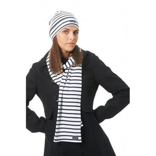 Woman wearing navy and white striped cotton scarf and matching beanie over a black coat