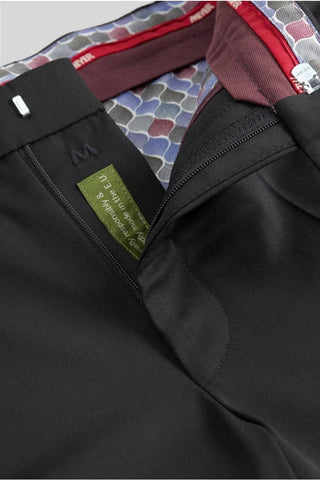Close-up of black wool dress pants with zip fly and patterned waistband lining