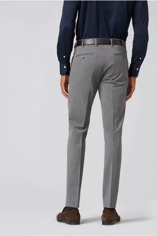 Men's light grey wool dress pants, slim fit, shown from the back, with brown belt and loafers
