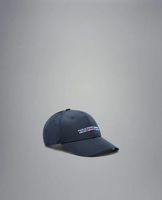 Navy nylon yachting cap with embroidered nautical flags and text on front, displayed on gray background