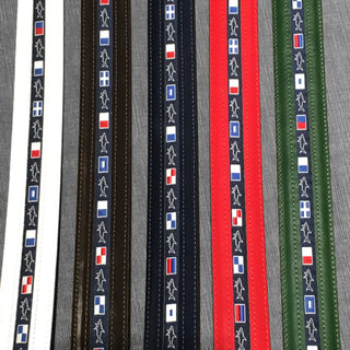 Leather belts in assorted colors featuring nautical flag patterns and embroidered shark design