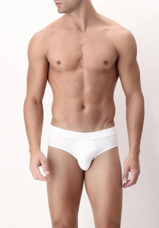 Man wearing white men's briefs, minimalist underwear, neutral background