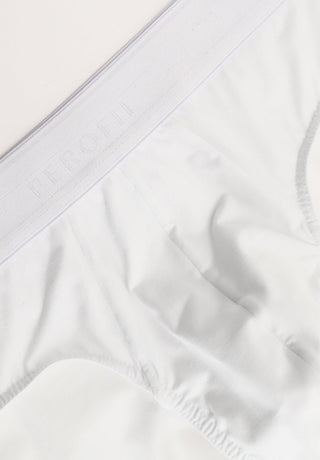 Close-up of white men's cotton briefs with elastic waistband and subtle logo detail
