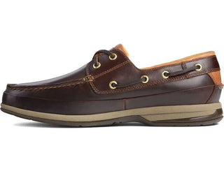 Men’s brown leather boat shoe with moc toe, gold eyelets, tan accents, and rubber sole