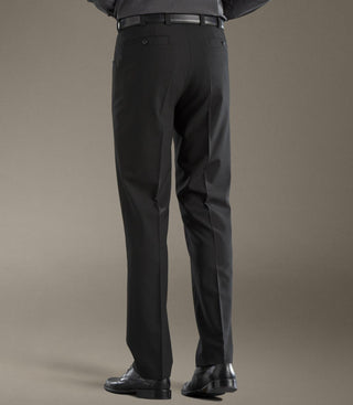 Back view of man wearing black dress pants, black belt, and black shoes on neutral background